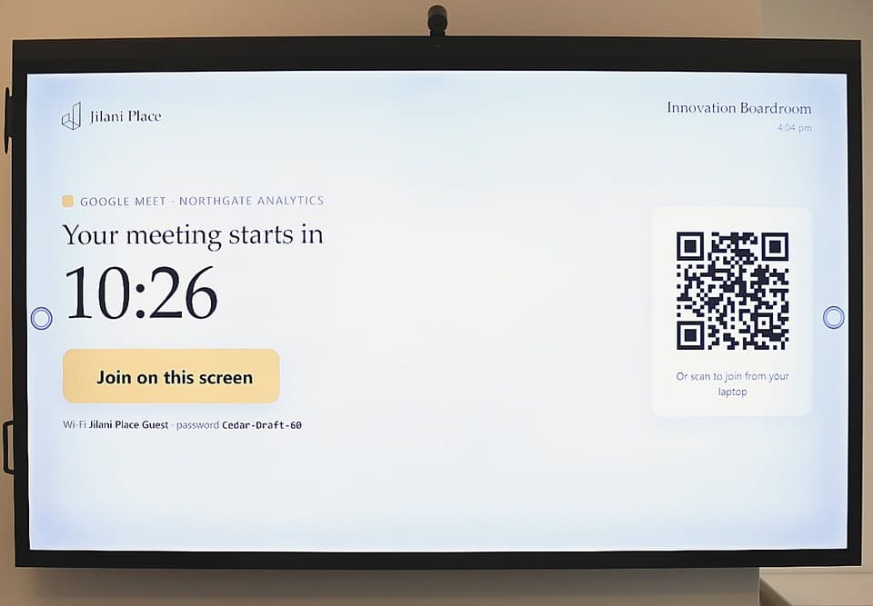The Innovation Boardroom screen counting down to a meeting, with a join button and a QR code