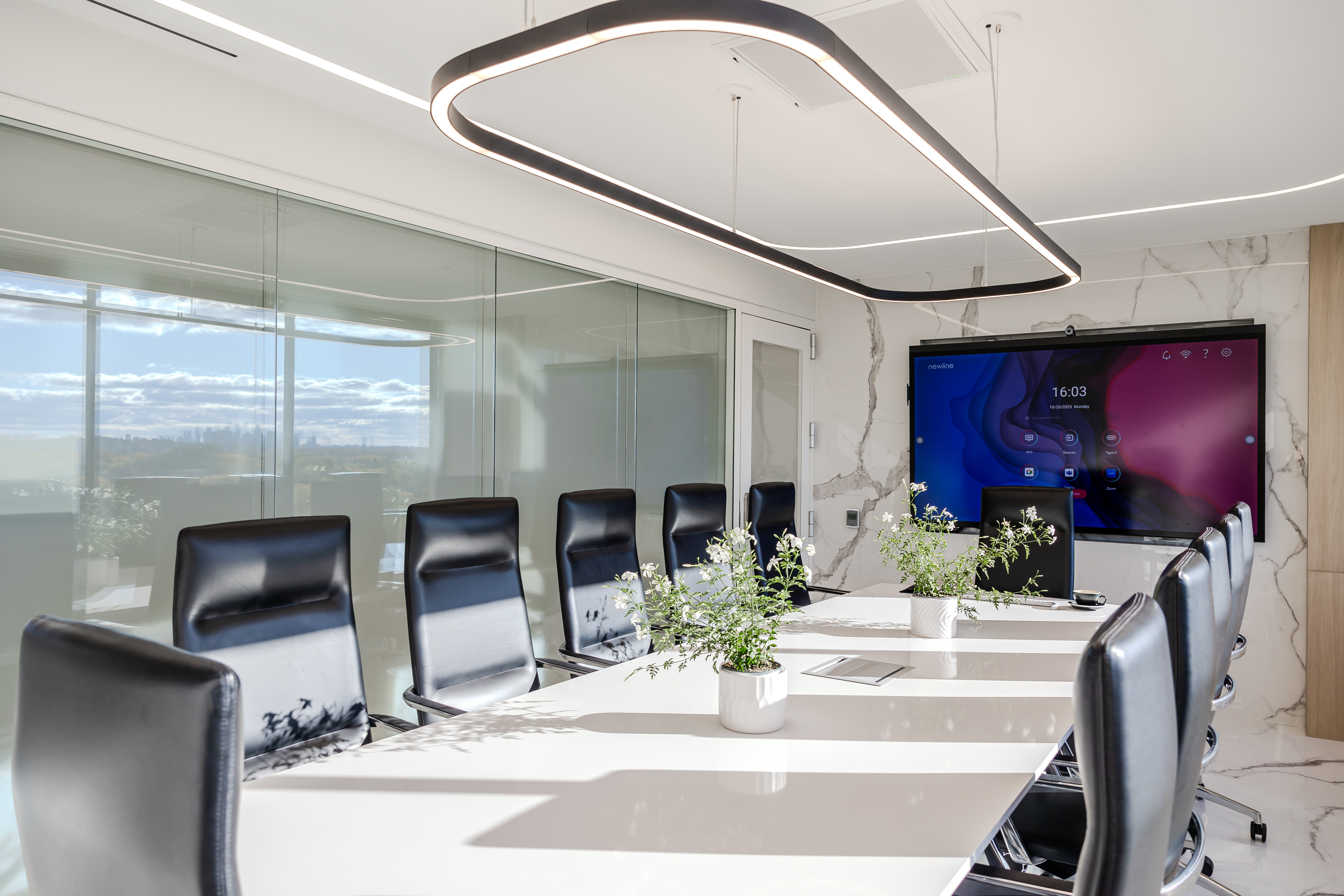 Large boardroom with long table and professional AV