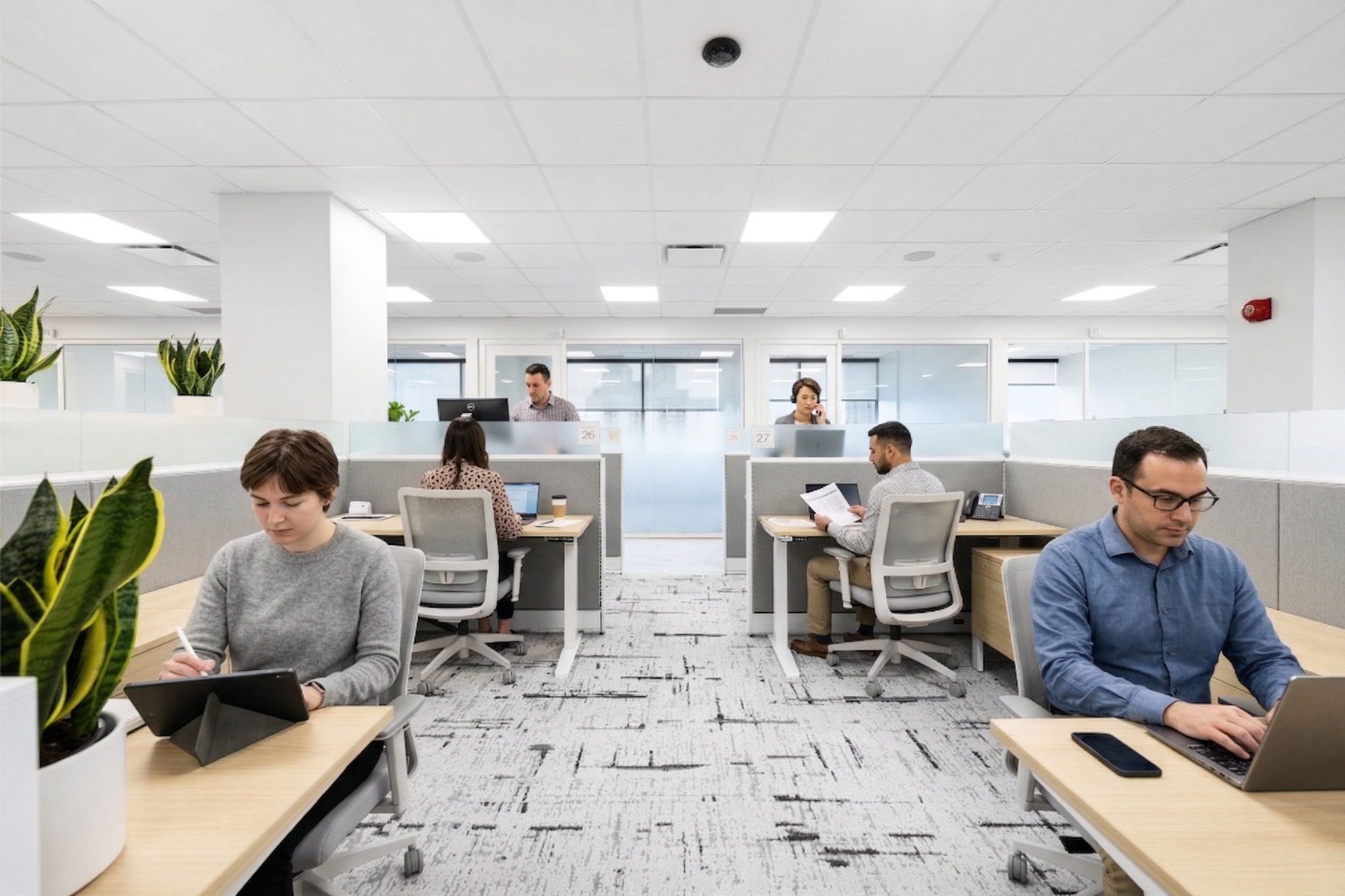 Hot desk area with people working at desks